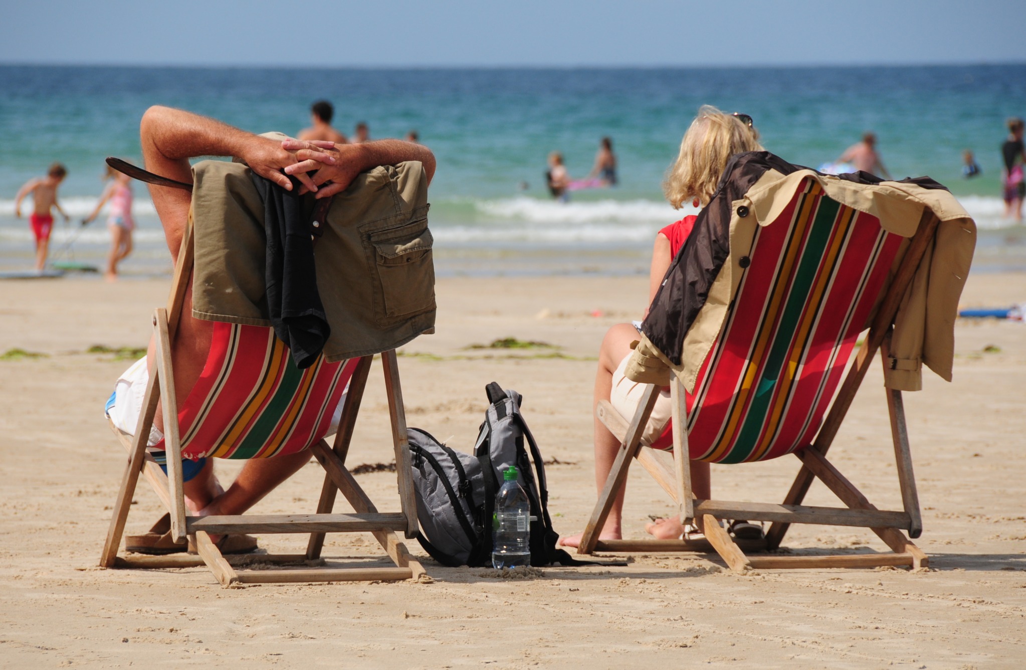 A couple relaxing in deckchairs overlooking the sea